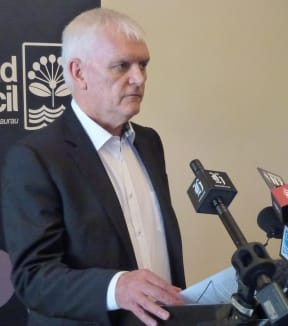 Doug McKay announcing the findings of the review in December 2013.