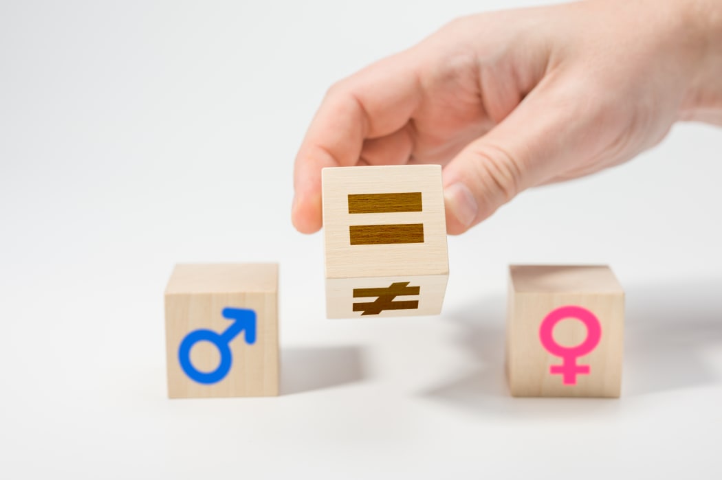 gender equality concept on wooden cubes. Concepts of gender equality. Hand flip wooden cube with symbol unequal change to equal sign. white background