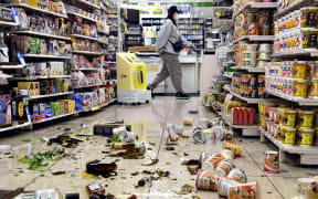Fallen bottles and other products at a convenience store in Fukushima City, Fukushima prefecture on March 16, 2022.