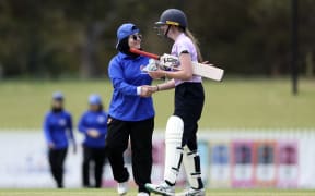 Players from the Afghanistan Women's XI and Cricket Without Borders XI shake hands at at Junction Oval in Melbourne on January 30, 2025. Afghanistan's women cricketers played their first game since fleeing the Taliban three years ago.