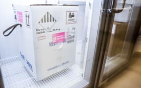 A box containing a shipment of the Pfizer-BioNTech Covid-19 vaccine sits in a freezer at a Colorado medical centre.