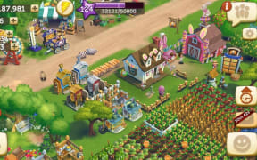 A screenshot of Farmville. It shows fields filled with crops, machines, and stalls selling produce.