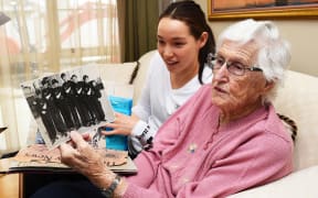 New Zealand's oldest living Olympian 92 year old Ngaire Galloway and granddaughter Gina Galloway look over 1948 Olympic memorabilia.