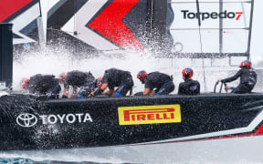 Team New Zealand brace through a wave in the third day of America's Cup racing.