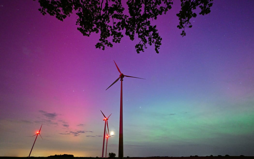10 May 2024, Brandenburg, Sieversdorf: Light green and violet-reddish auroras glow in the night sky in the Oder-Spree district of East Brandenburg. The northern lights (aurora borealis) are produced by a cloud of electrically charged particles from a solar storm in the earth's atmosphere. Photo: Patrick Pleul/dpa (Photo by PATRICK PLEUL / DPA / dpa Picture-Alliance via AFP)