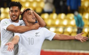 Captain Bill Tuiloma and Clayton Lewis celebrate a goal against Myanmar
