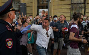 People react outside the Belarusian embassy after a polling station was closed during Belarus' presidential election.
