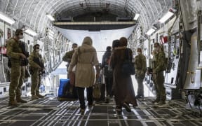 People disembark from an Australian Air Force plane after being evacuated from Afghanistan