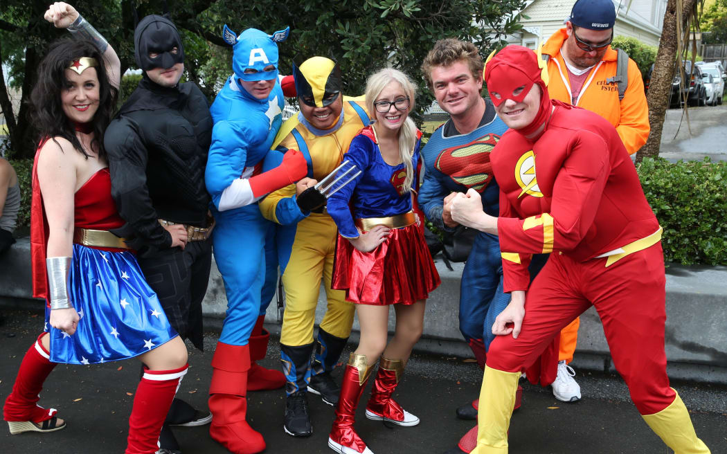 Fans dressed up as superheroes pose before heading into Eden Park for the NRL Nines