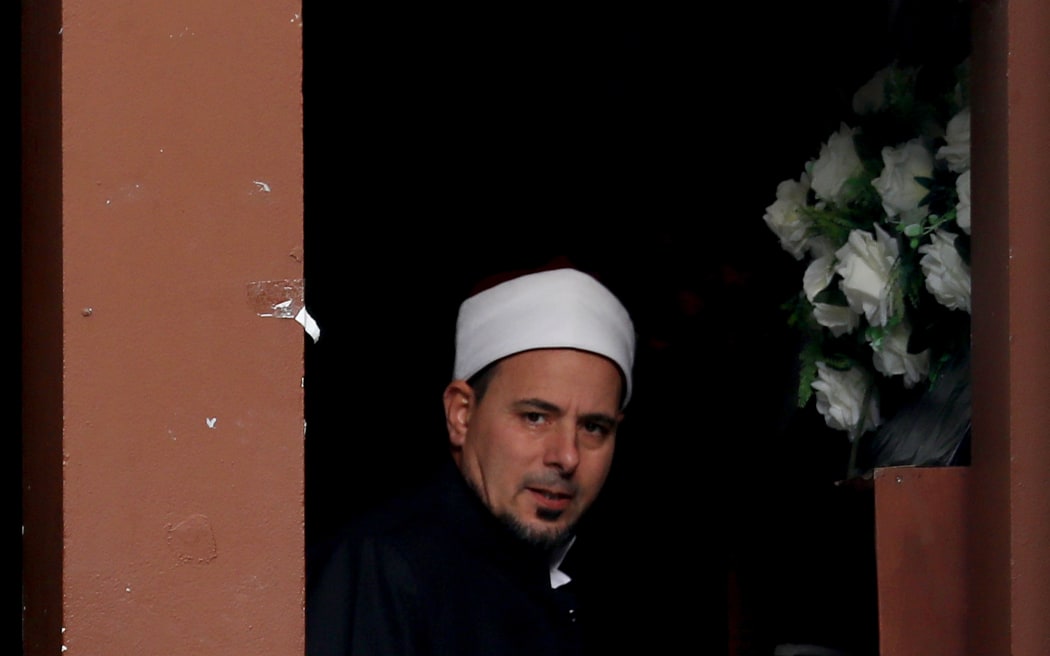 Imam Gamal Fouda looks through a window at the Al Noor mosque in Christchurch, New Zealand on March 15, 2020.