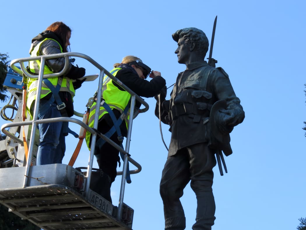 Art restoration team Carolina Izzo, right, and Maria Pagu at work on the cenotaph at Masterton's Queen Elizabeth Park