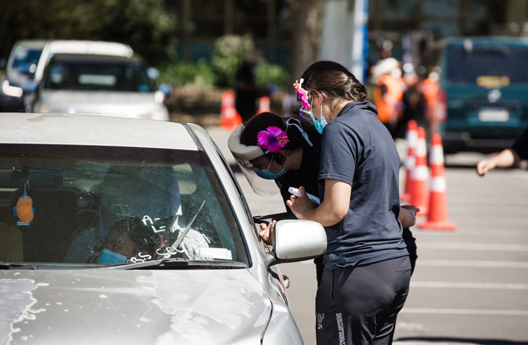 Lines of cars stretch out at the MIT carpark in Ōtara for the Super Saturday vaccination event