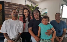 PM Jacinda Ardern pictured with state abuse victims.