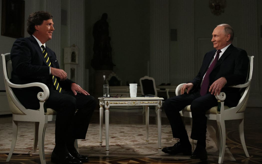 In this pool photograph distributed by Russian state agency Sputnik, Russia's President Vladimir Putin gives an interview to US talk show host Tucker Carlson at the Kremlin in Moscow on February 6, 2024. (Photo by Gavriil GRIGOROV / POOL / AFP)