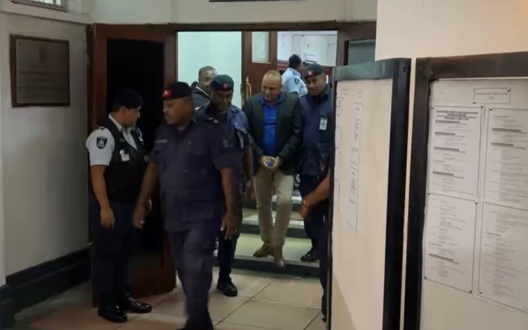 Qiliho walks out of the Suva High Court and escorted by police officers to the be taken to jail. 9 May 2024