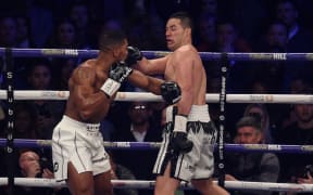 Anthony Joshua (L) of Great Britain and Joseph Parker (R) of New Zealand feel each other out in the first round of their heavyweight boxing unification bout at Principality Stadium in Cardiff, March 31, 2018.
