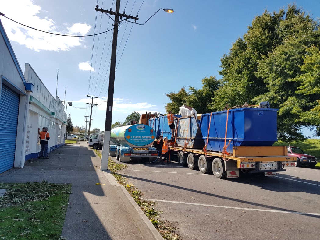 Rubbish being loaded onto a truck.