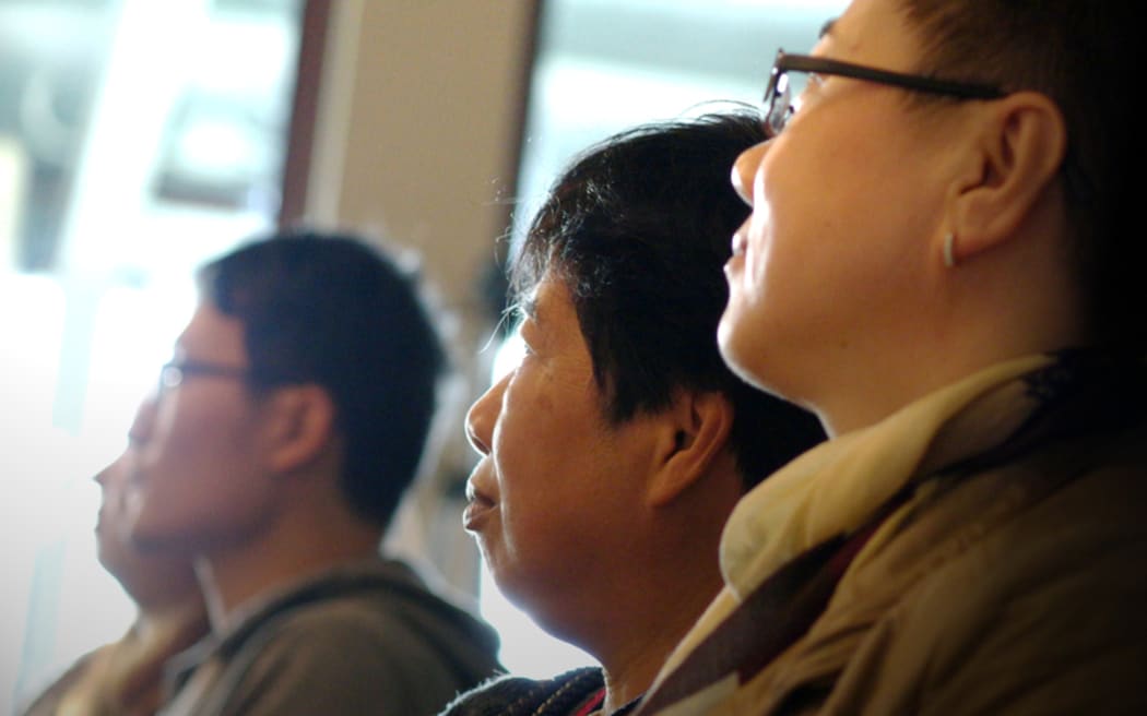Potential buyers at a house auction in Manukau, Auckland.