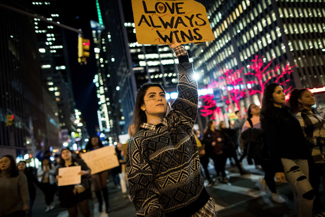 NEW YORK, NY - NOVEMBER 11: Anti-Donald Trump protesters march in the street on Fifth Avenue, November 11, 2016 in New York City. The election of Trump as president has sparked protests in cities across the country. Drew Angerer/Getty Images/AFP