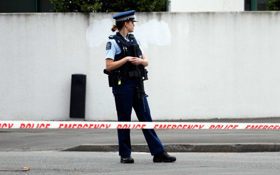 A police officer secures the area in front of the Masjid al Noor mosque on Friday.