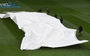 The covers over the wicket as the rain arrives.