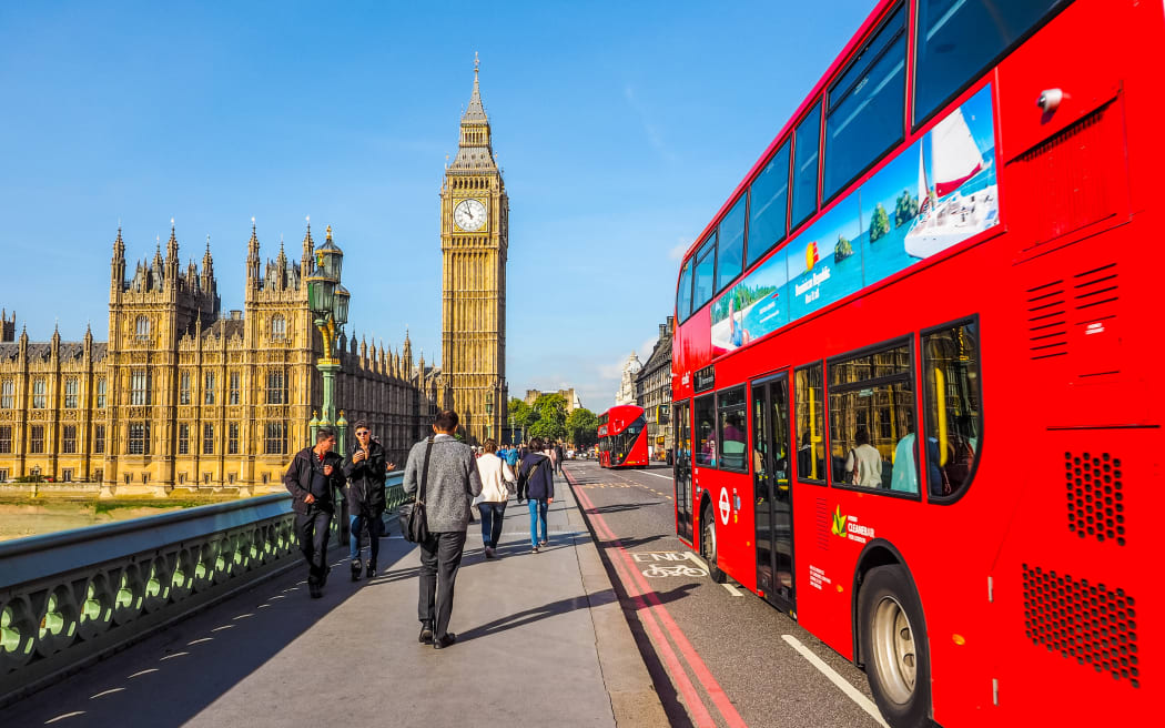 LONDON, UK - SEPTEMBER 28, 2015: Tourists on Westminster Bridge at the Houses of Parliament aka Westminster Palace (HDR). london generic