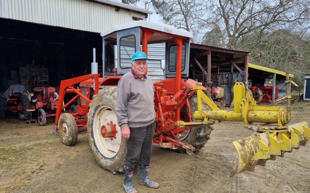 Jim Papps standing in front of one of his tractors following bad weather in Tasman District.