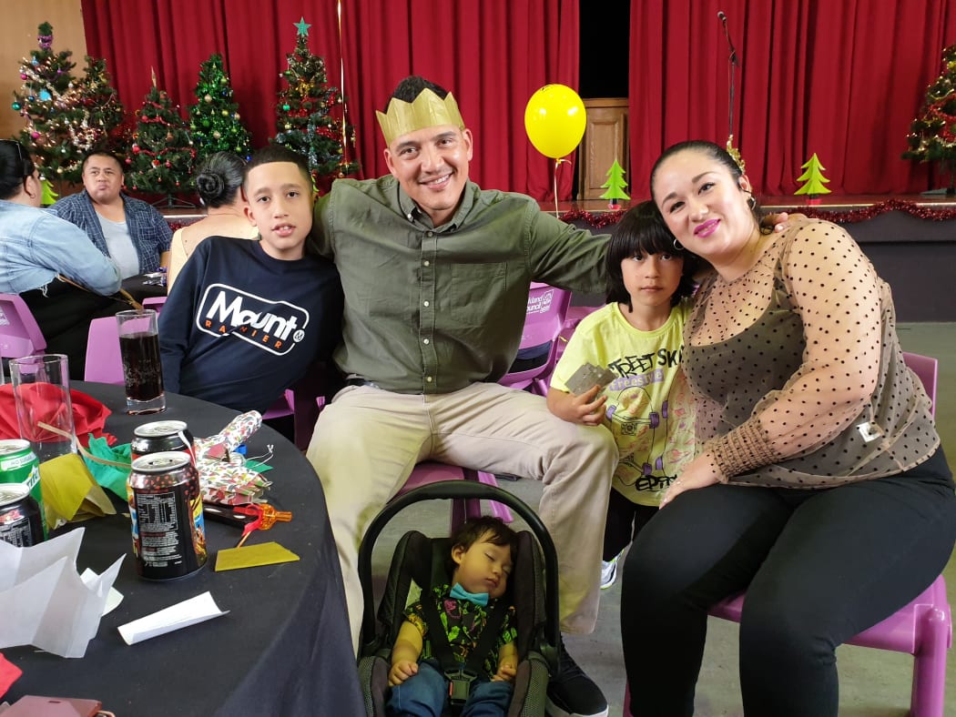 Joseph Castro and Yasmin Rojas with their three children Allen, Justin and Brandon say they feel more connected coming to the City Mission's Christmas lunch.