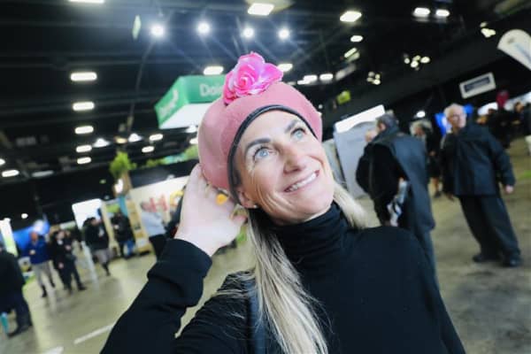 Shantell Carter, from Cambridge, is wearing her pink hat and staying dry inside the shed as the rain pushes on at Fieldays on 12 June, 2025.