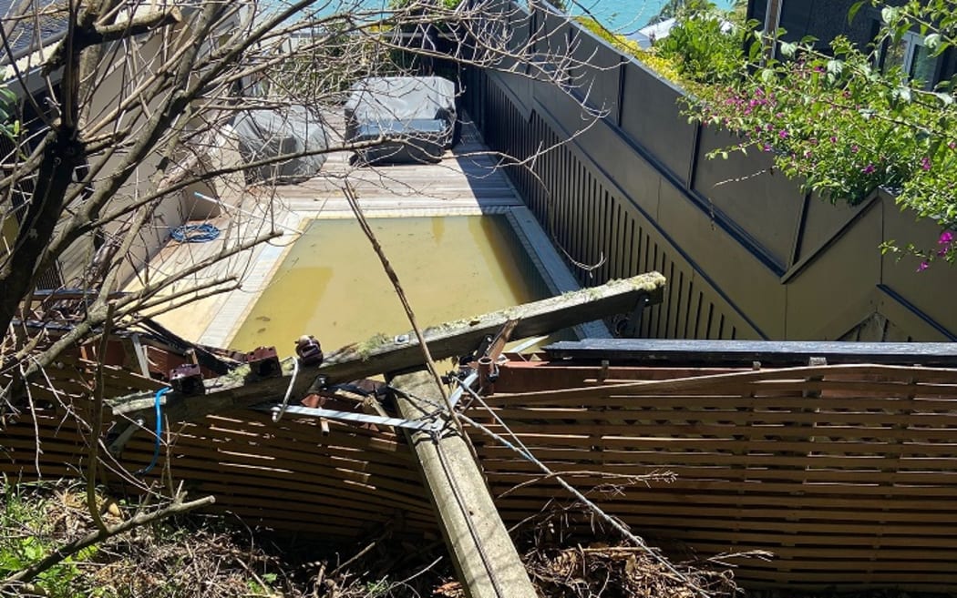 A power line down across Andy Fenton's fence and some of the debris before the clean-up.