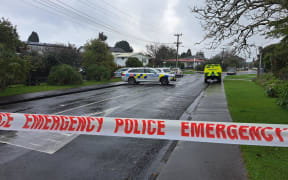 Police cars and cordons are seen at the end of Graham Avenue in Te Atatū. At least eight police, and two St John vehicles are in attendance.
