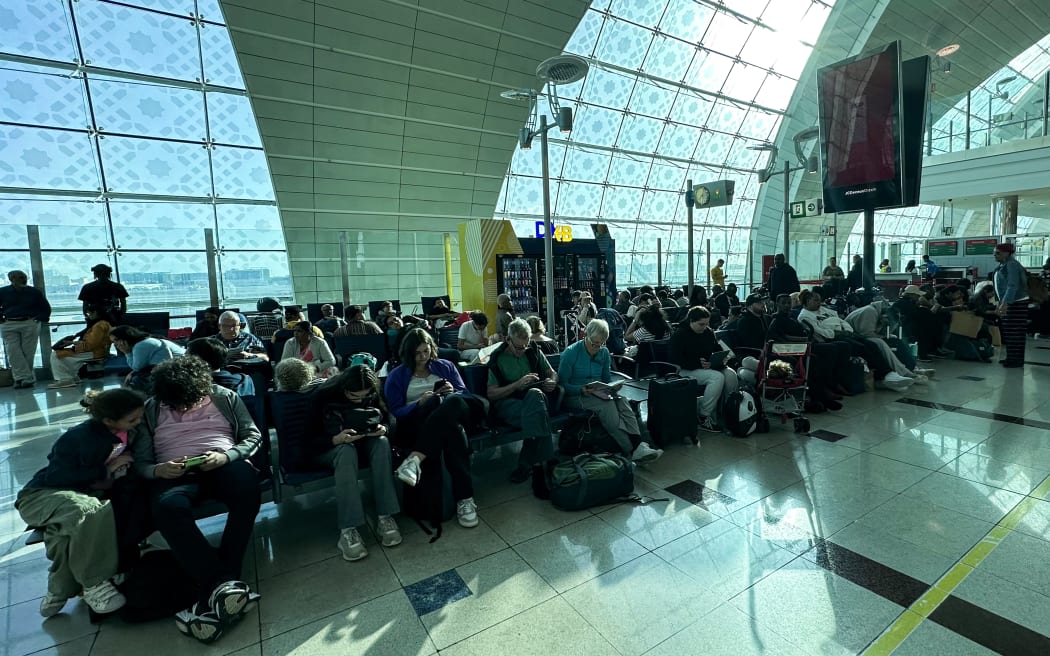 Passengers wait for their flights at the Dubai International Airport in Dubai on April 17, 2024. Dubai's major international airport diverted scores of incoming flights on April 16 as heavy rains lashed the United Arab Emirates, causing widespread flooding around the desert country. Dubai, the Middle East's financial centre, has been paralysed by the torrential rain that caused floods across the UAE and Bahrain and left 18 dead in Oman on April 14 and 15. (Photo by AFP)