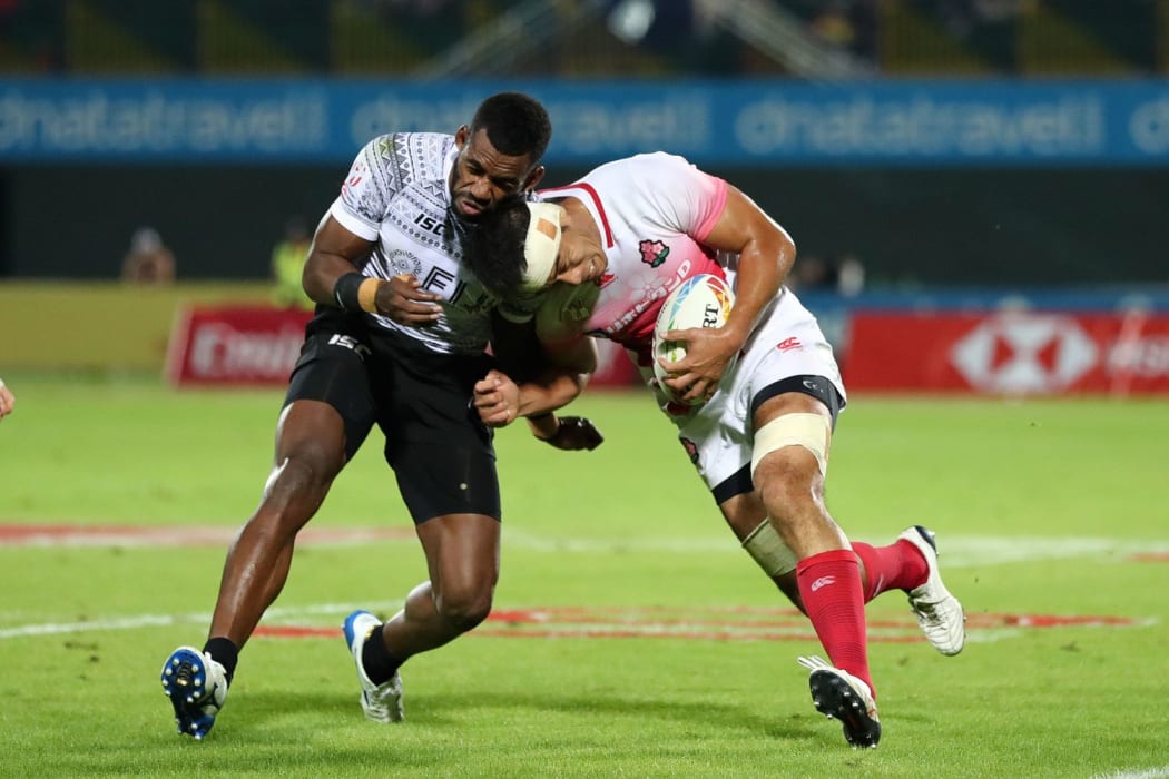 Japan's Yusaku Kuwazuru goes head to head against Fiji's Sevuloni Mocenacagi on day one of the Dubai Sevens