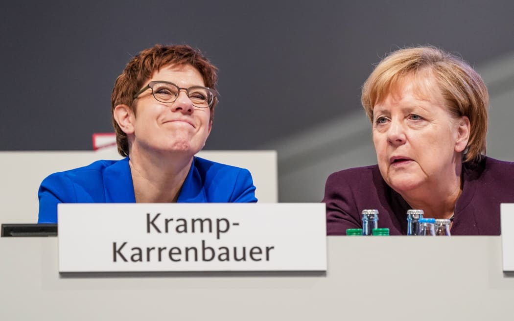 22 November 2019, Saxony, Leipzig: Annegret Kramp-Karrenbauer, federal chairman of the CDU and defense minister, talks to Chancellor Angela Merkel (CDU) at the CDU federal party conference. The party conference will last until 23 November 2019. Photo: Michael Kappeler/dpa