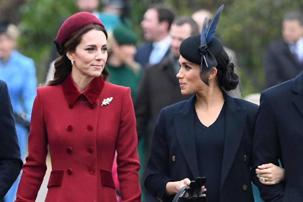 Britain's Catherine, Duchess of Cambridge (L) talks to Meghan, Duchess of Sussex as they arrive for the Royal Family's traditional Christmas Day service at St Mary Magdalene Church in Sandringham, Norfolk, eastern England, on December 25, 2018.