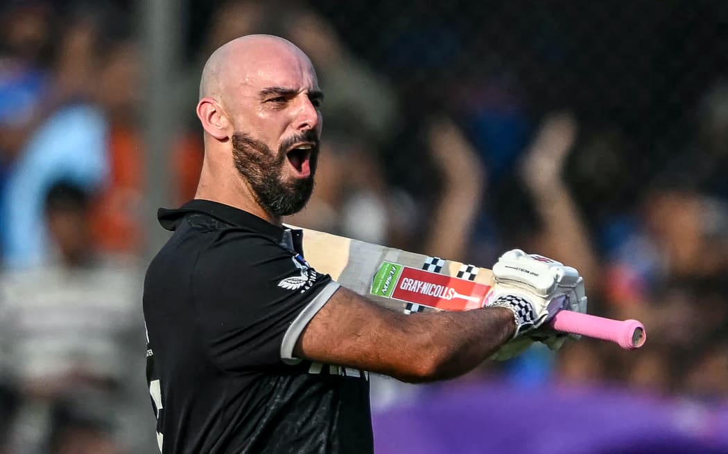 New Zealand's Daryl Mitchell celebrates after scoring a century (100 runs) during the third one-day international (ODI) cricket match between India and New Zealand at the Holkar Cricket Stadium in Indore on January 18, 2026. (Photo by Indranil MUKHERJEE / AFP) / -- IMAGE RESTRICTED TO EDITORIAL USE - STRICTLY NO COMMERCIAL USE --