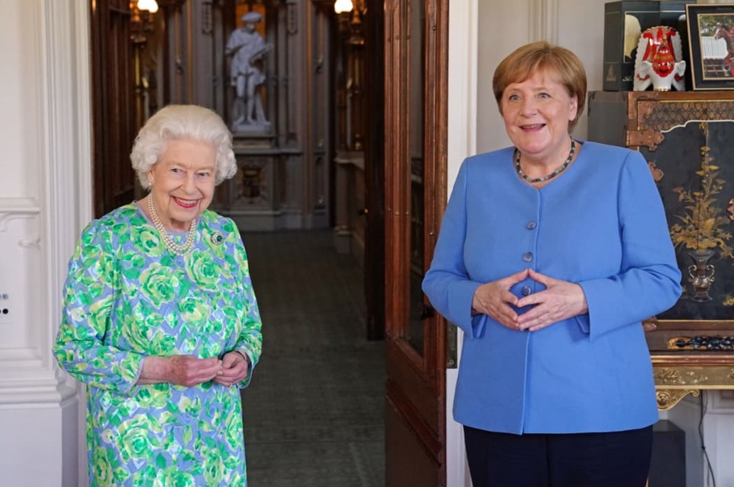 Britain's Queen Elizabeth II receives German Chancellor Angela Merkel during an audience at Windsor Castle in Windsor, Berkshire on July 2, 2021.