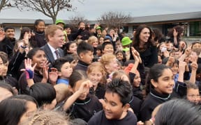 Education Minister Chris Hipkins and PM Jacinda Ardern with school students following today's announcement.
