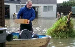 Paraparaumu resident Justin Patterson moves his furniture.