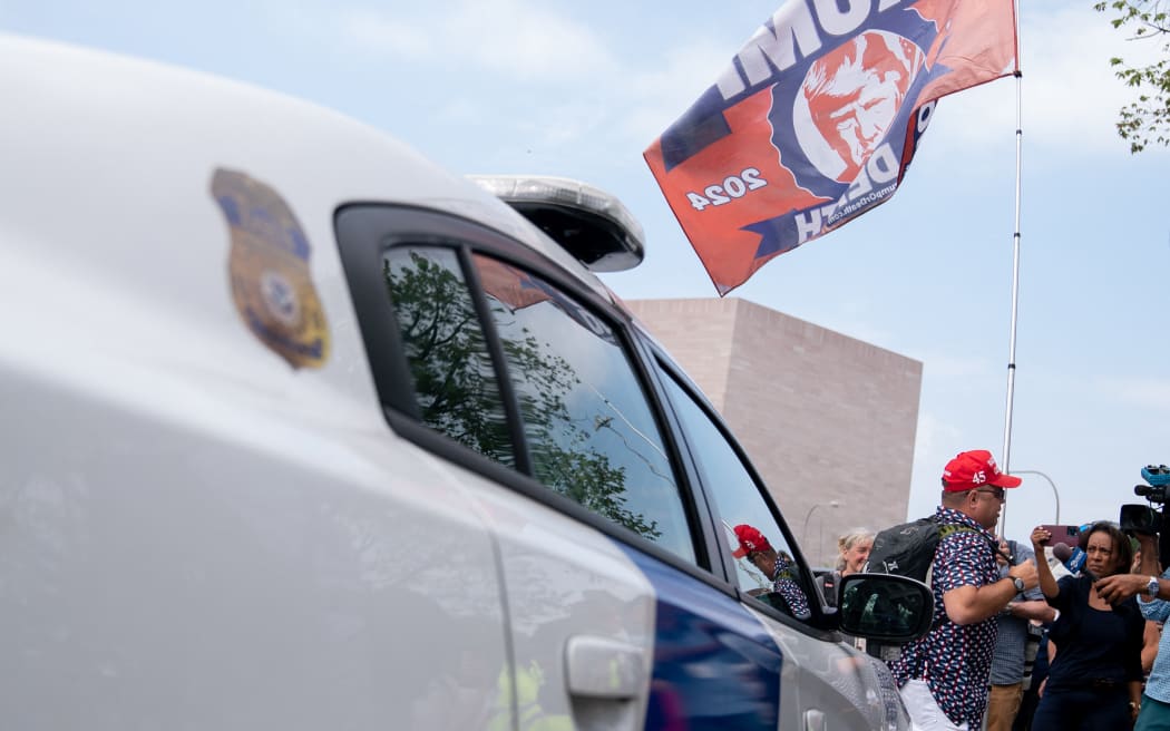 A supporter of former US President Donald Trump outside the E. Barrett Prettyman US Courthouse in Washington, DC, on 3 August, 2023, ahead of Trump's arraignment.
