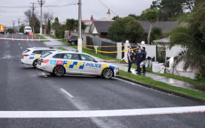 Police at the street where a woman was shot in Henderson, West Auckland.