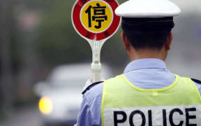 A Chinese police officer stops a car during a drunk driving test in Huaibei city, east Chinas Anhui province, 1 May 2011.

Many drunk drivers across China have been charged with dangerous driving and will soon face criminal punishment under Chinas newly amended Road Traffic Safety Law, which took effect on Sunday (1 May 2011). The new amendment will revoke the licenses of those caught driving drunk and make such drivers wait five years before they may apply for a new license. Anyone whose drunk driving leads to a death or the injury of at least two persons will be banned from driving for life. Drivers found to have committed severe violations will go to prison. (Photo by Zhang hongxin / Imaginechina / Imaginechina via AFP)