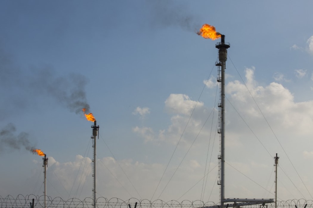 This picture shows gas flares at the Basrah Gas Company's (BGC) facilities in Basra on February 11, 2019. (Photo by Hussein FALEH / AFP)