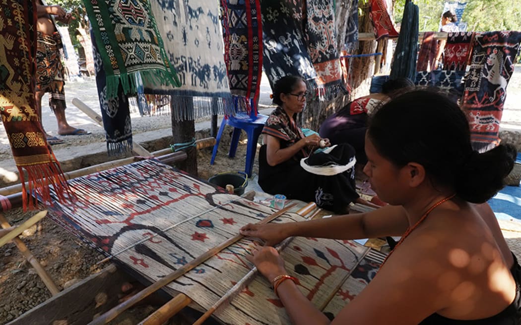 Weavers demonstrate the making of ikat textiles on Sumba Island, Indonesia