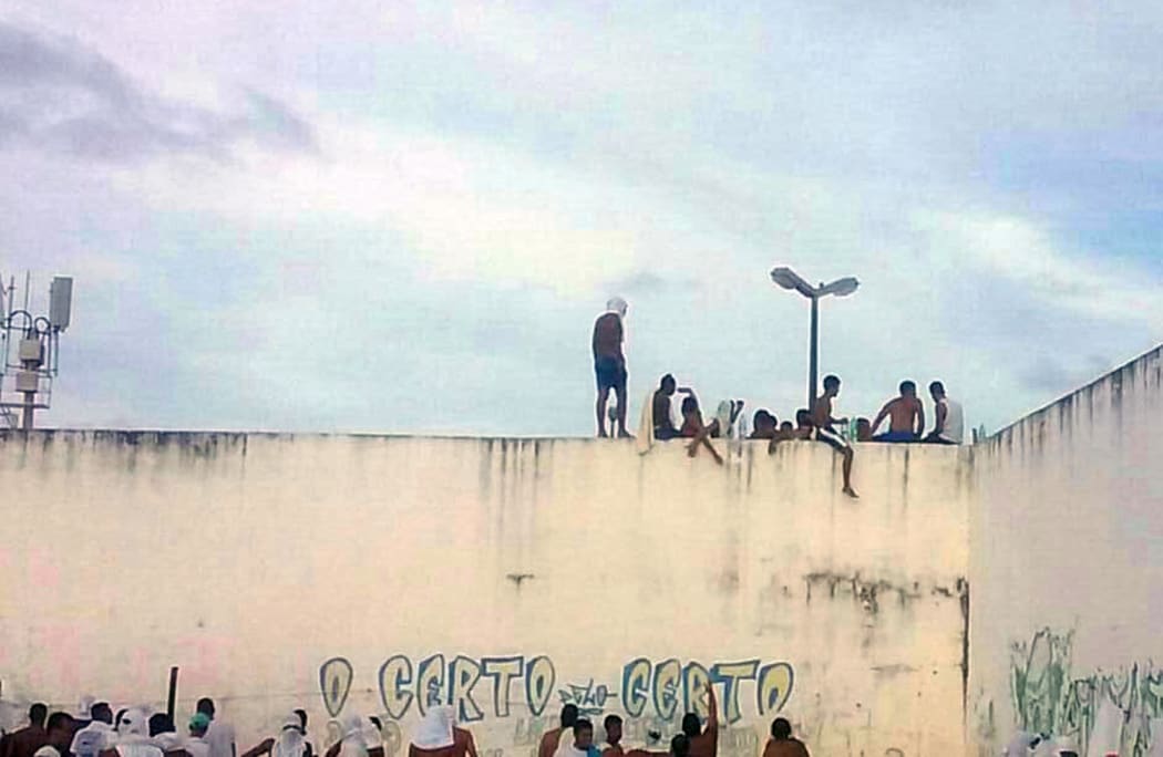 Inmates are seen during the prison riot.