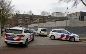 Police vehicles are parked outside a Jewish school where an explosion was reported overnight in Amsterdam on March 14, 2026. An overnight blast against an exterior wall of a Jewish school in Amsterdam did not cause any injuries, Mayor Femke Halsema said March 14, 2026, denouncing "a cowardly act of aggression". An investigation has been opened and the incident comes after nighttime attacks this week in front of synagogues in the Belgian city of Liege and the Dutch port city of Rotterdam. (Photo by Michel van Bergen / ANP / AFP) / Netherlands OUT