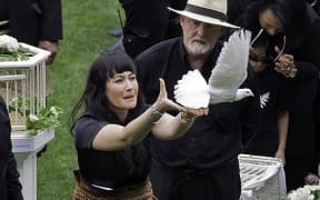 Jonah Lomu's widow, Nadene, releases the first of a flock of white doves into the air over Eden Park.