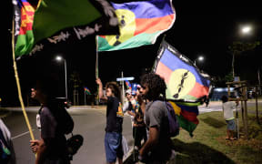 Kanak independence supporters wave flags of the Socialist Kanak National Liberation Front (FLNKS) after the referendum on independence on the French South Pacific territory of New Caledonia in Noumea on October 4, 2020. (Photo by Theo Rouby / AFP)