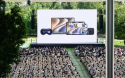 Attendees watch a screen during the Worldwide Developers Conference (WWDC) at Apple Park in Cupertino, California, on June 8, 2026. (Photo by Josh Edelson / AFP)