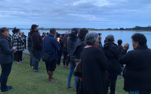 About 50 whānau, friends and members of the local community gather for a karakia at the cordon at the Whakatāne Boat Ramp.